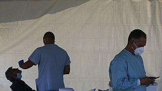 A health worker carries out COVID-19 tests of a resident of Larnaca, a resort town in southern coast of Cyprus