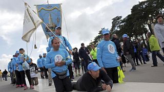 A group of pilgrims paying penance move towards the Chapel of the Apparitions at the Fatima Sanctuary Thursday, May 11 2017, in Fatima, Portugal.