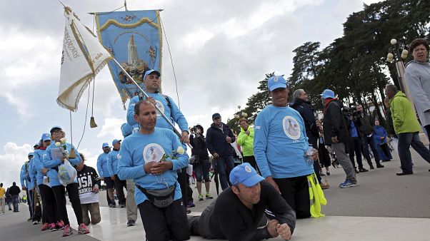 A group of pilgrims paying penance move towards the Chapel of the Apparitions at the Fatima Sanctuary Thursday, May 11 2017, in Fatima, Portugal. A group of pilgrims paying penance move towards the Chapel of the Apparitions at the Fatima Sanctuary Thursday, May 11 2017, in Fatima, Portugal.