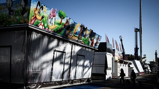 People walk in an alley of the Pleasure Fair, a funfair organised since 1854 in Bordeaux, and which has been severely limited due to COVID-19. People walk in an alley of the Pleasure Fair, a funfair organised since 1854 in Bordeaux, and which has been severely limited due to COVID-19.