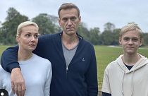 Navalny, centre, poses for a photo with his wife Yulia and their son Zahar in an unknown location in Germany.
