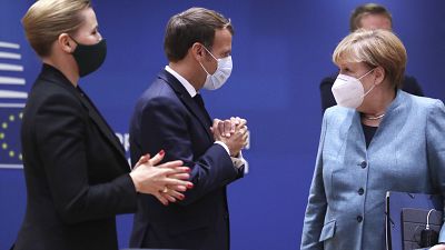 German Chancellor Angela Merkel, right, speaks with Denmark's Prime Minister Mette Frederiksen