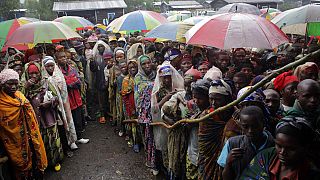 In this Aug. 8, 2012, file photo, internally displaced Congolese men and women wait for a World Food Program energy biscuits to be distributed in Kibati, north of Goma.