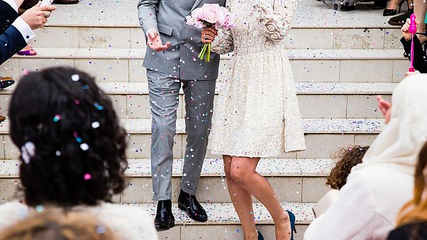 File photo: A bride and groom are pictured surrounded by wedding guests. File photo: A bride and groom are pictured surrounded by wedding guests.