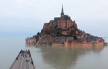 Wide shot Mont-Saint-Michel surrounded by the sea during high tide (drone images)