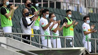 FILE-In this May 31, 2020 file photo Moenchengladbach alternate players wearing face masks applaud during the German Bundesliga match against Union Berlin.