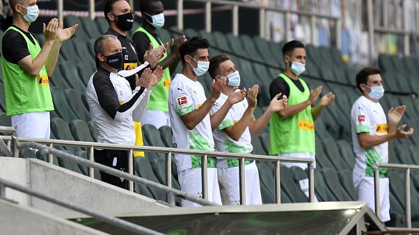 FILE-In this May 31, 2020 file photo Moenchengladbach alternate players wearing face masks applaud during the German Bundesliga match against Union Berlin. FILE-In this May 31, 2020 file photo Moenchengladbach alternate players wearing face masks applaud during the German Bundesliga match against Union Berlin.