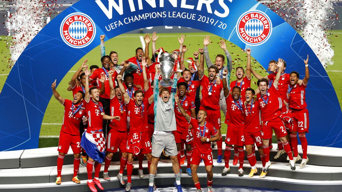 Bayern's goalkeeper Manuel Neuer lifts the trophy after Munich won the Champions League final soccer match.