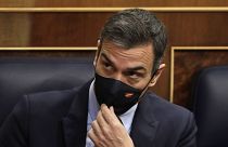 Spain's Prime Minister Pedro Sanchez adjusts his face mask at a parliamentary session ahead of a no-confidence vote. Madrid, Spain. October 21, 2020.