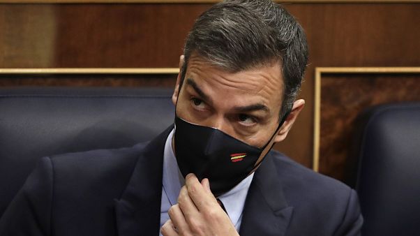Spain's Prime Minister Pedro Sanchez adjusts his face mask at a parliamentary session ahead of a no-confidence vote. Madrid, Spain. October 21, 2020. Spain's Prime Minister Pedro Sanchez adjusts his face mask at a parliamentary session ahead of a no-confidence vote. Madrid, Spain. October 21, 2020.