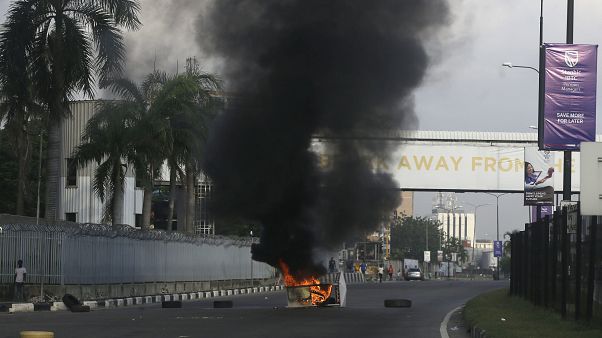 After 13 days of protests against alleged police brutality, authorities have imposed a 24-hour curfew in Lagos. After 13 days of protests against alleged police brutality, authorities have imposed a 24-hour curfew in Lagos.