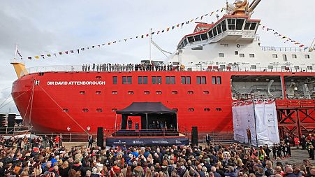 The Duke of Cambridge, Duchess of Cambridge and Sir David Attenborough (seated on the stade) attend the naming ceremony of Britain's new polar research ship.