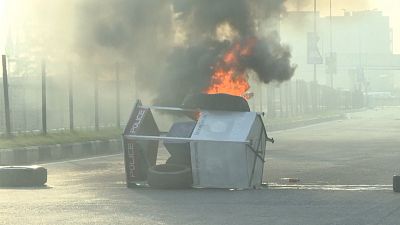 Overturned toll booth on fire