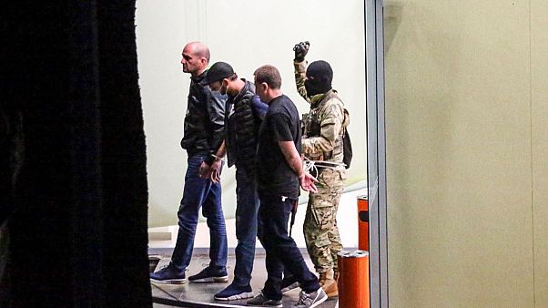 A gunman could be seen escorting three individuals out of the bank building on Wednesday. A gunman could be seen escorting three individuals out of the bank building on Wednesday.