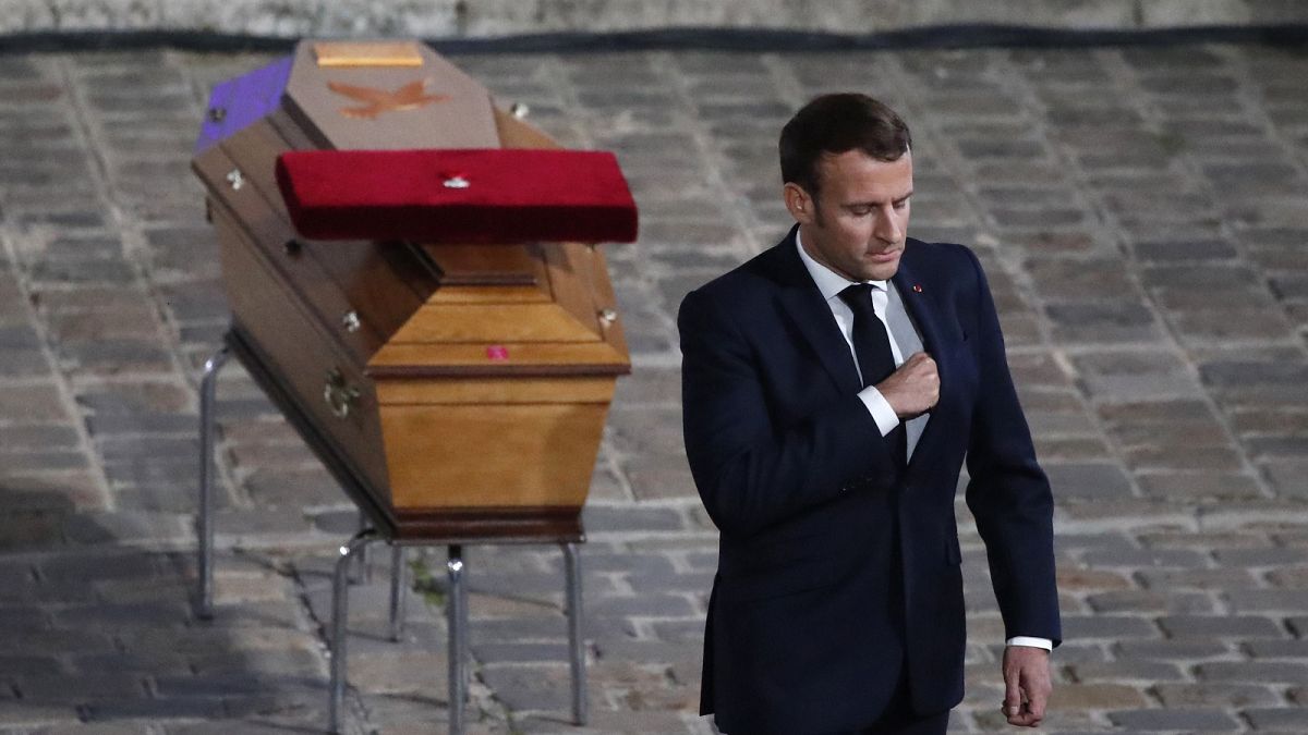 French President Emmanuel Macron leaves after paying his respects by the coffin of slain teacher Samuel Paty in the courtyard of the Sorbonne university, Paris.