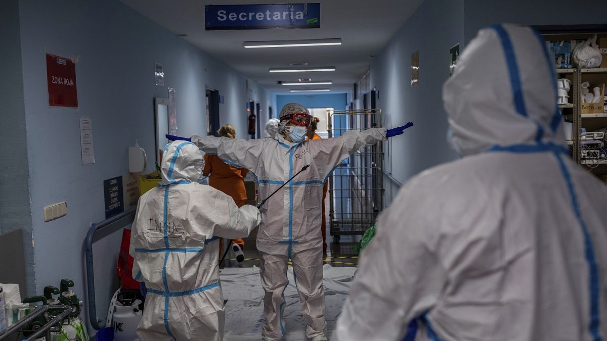 A medical team member is disinfected before leaving the COVID-19 ward at the Severo Ochoa hospital in Leganes, outskirts of Madrid, Spain.