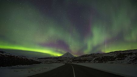 Northern Lights, or aurora borealis, appear in the sky over Bifrost, Western Iceland.