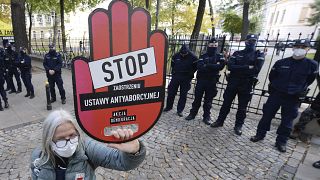 A protester holds a sign reading "stop tightening the law" at a pro-choice protest in front of Poland's constitutional court. Warsaw, Poland. Oct. 22, 2020.