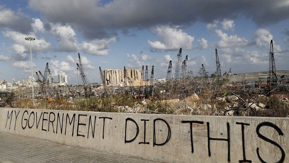 Political graffiti is visible in front of the scene of the August 4 explosion that hit the seaport of Beirut, Lebanon.