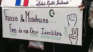 Close-up of a sign saying "French and Muslim, proud of our two identities", during a march against Islamophobia in France