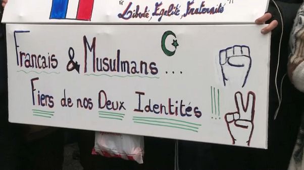 Close-up of a sign saying "French and Muslim, proud of our two identities", during a march against Islamophobia in France Close-up of a sign saying "French and Muslim, proud of our two identities", during a march against Islamophobia in France