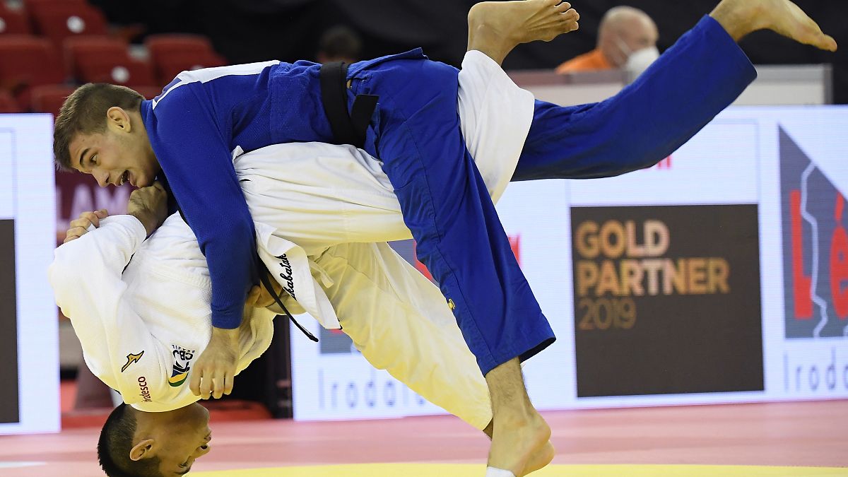 Eric Takabatake, bottom, of Brazil and Marton Andrasi of Hungary fight in the men's -66 kg category of the Judo Grand Slam Budapest