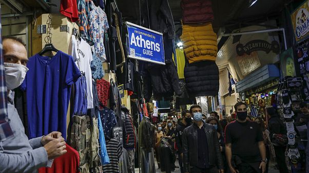 University students wearing face masks to curb the coronavirus protest as they walk in Monastiraki flea market in Athens University students wearing face masks to curb the coronavirus protest as they walk in Monastiraki flea market in Athens