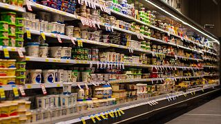 Products line the shelves of a supermarket.