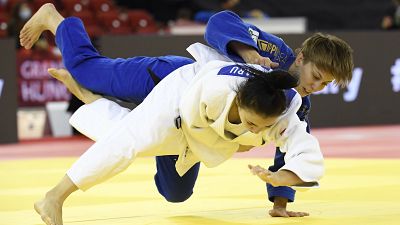 Reka Pupp, top, of Hungary and Cristina Blanaru of Moldova fight in the women's -52 kg category of the Judo Grand Slam Budapest