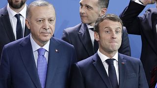 Turkey's President Recep Tayyip Erdogan, left and French President Emmanuel Macron stand, during a group photo at a conference on Libya in Berlin.