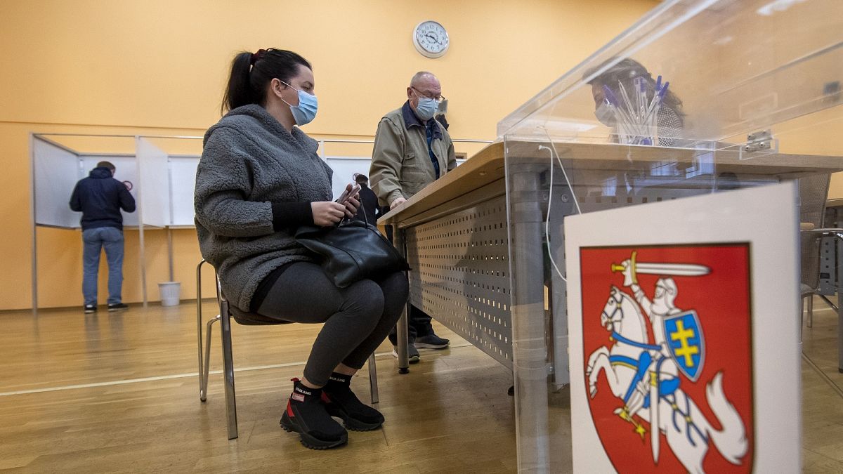 Lithuanians wait for ballots at a polling station during early voting in the second round of elections in Vilnius, Lithuania, on Thursday, October 22, 2020.
