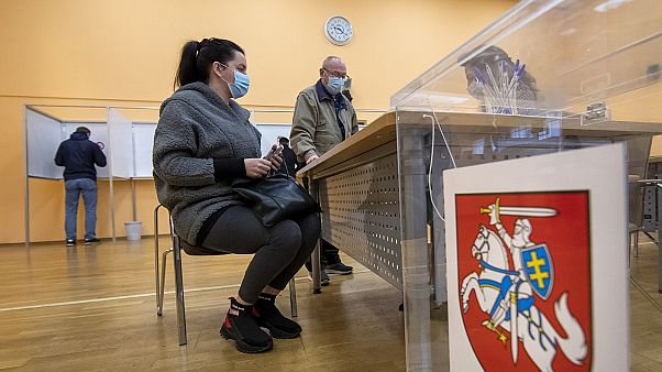 Lithuanians wait for ballots at a polling station during early voting in the second round of elections in Vilnius, Lithuania, on Thursday, October 22, 2020. Lithuanians wait for ballots at a polling station during early voting in the second round of elections in Vilnius, Lithuania, on Thursday, October 22, 2020.