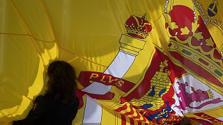 A woman holds a Spanish flag during a memorial for coronavirus victims in Madrid, Spain, Friday, October 23, 2020.