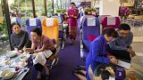 A flight attendant serves welcome drinks in a flight-themed restaurant at the Thai Airways head office in Bangkok