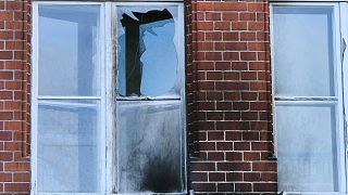 The damaged windows of the Robert Koch Institute in Berlin, Germany, Sunday, Oct.25, 2020. According to police, bottles and incendiary devices were thrown at the building.