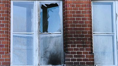 The damaged windows of the Robert Koch Institute in Berlin, Germany, Sunday, Oct.25, 2020. According to police, bottles and incendiary devices were thrown at the building.