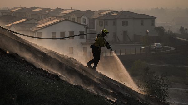 Firefighter Tylor Gilbert puts out hotspots while battling the Silverado Fire, Monday, Oct. 26, 2020, in Irvine, California, USA. Firefighter Tylor Gilbert puts out hotspots while battling the Silverado Fire, Monday, Oct. 26, 2020, in Irvine, California, USA.