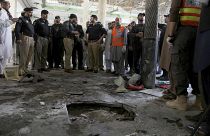 Police officers examine the site of bomb explosion in an Islamic seminary in Peshawar, Pakistan, Tuesday, Oct. 27, 2020.