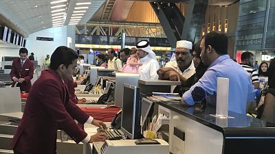In this Monday, June 12, 2017 photo, Qatari and other nationals queue at the check in counters of the Hamad International Airport in Doha, Qatar