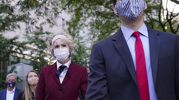 E. Jean Carroll, centre, who says President Donald Trump raped her in the 1990s, leaves the courthouse following a hearing in her defamation suit. E. Jean Carroll, centre, who says President Donald Trump raped her in the 1990s, leaves the courthouse following a hearing in her defamation suit.