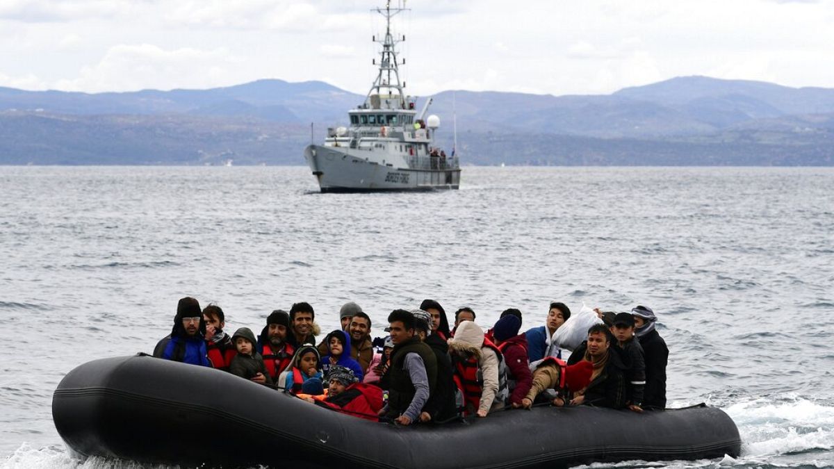 Migrants arrive with a dinghy accompanied by a Frontex vessel at the village of Skala Sikaminias