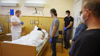 Volunteers take part in a one-day course, as part of a programme by the Czech Red Cross to create thousands of voluntary healthcare assistants, in a hospital in Prague.