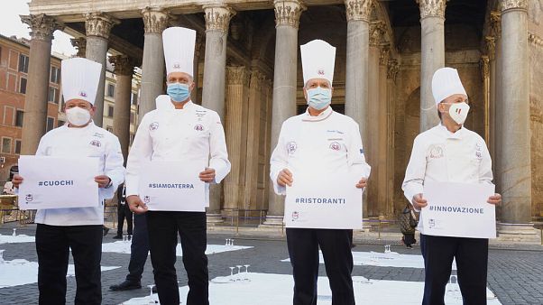 Cozinheiros em protesto em frente ao panteão de Roma com as mensagem "#cozinheiros", "#estamos por terra", "#restaurantes" e "#inovação" Cozinheiros em protesto em frente ao panteão de Roma com as mensagem "#cozinheiros", "#estamos por terra", "#restaurantes" e "#inovação"