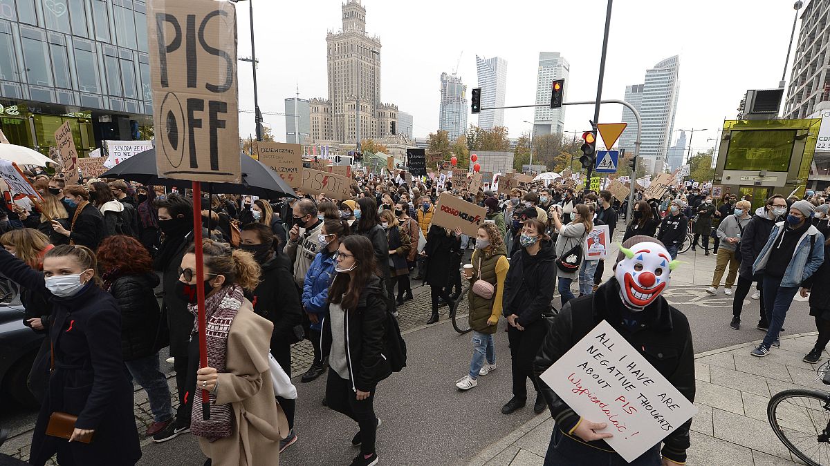 Women's rights activists with posters of the Women's Strike action protest in Warsaw, Poland, Wednesday, Oct. 28, 2020.