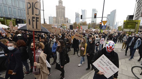 Women's rights activists with posters of the Women's Strike action protest in Warsaw, Poland, Wednesday, Oct. 28, 2020. Women's rights activists with posters of the Women's Strike action protest in Warsaw, Poland, Wednesday, Oct. 28, 2020.