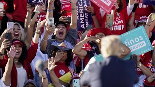 President Donald Trump acknowledges the cheering crowd behind him at a campaign rally at Phoenix Goodyear Airport Wednesday, Oct. 28, 2020, in Goodyear, Arizona.