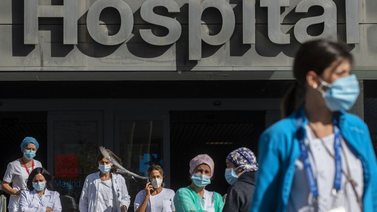 Medical staff and nurses wearing face masks gather during a protest demanding an improvement in wages and labour conditions at La Paz hospital in Madrid, Spain