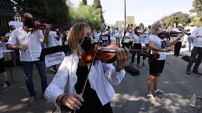 The Israel Philharmonic Orchestra performs outside Knesset in protest of Covid-19 lockdown measures