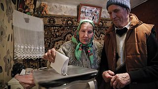 A woman casts her vote in a mobile ballot box in the village of Stolniceni, Moldova, Sunday, Feb. 24, 2019. 