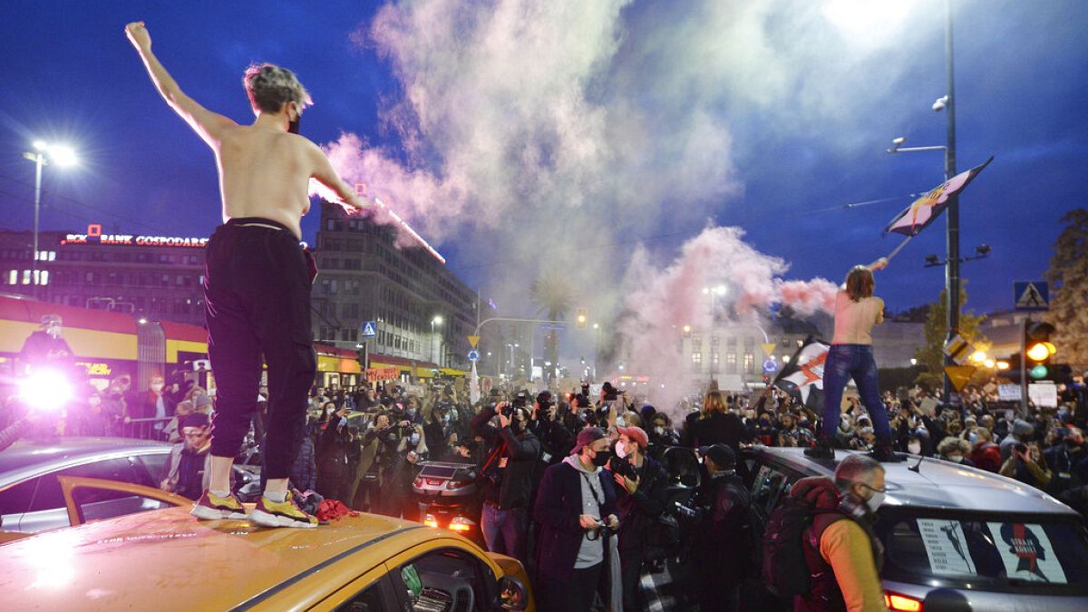 Women's rights activists and their supporters block rush-hour traffic in Warsaw during a pro abortion rally